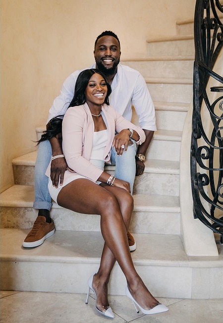 Sloane Stephens in front of her future husband Jozy Altidore sitting in the staircase steps.